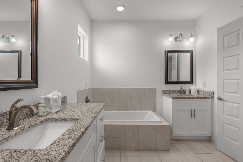 The primary bedroom's ensuite features a soaking tub and a shower.