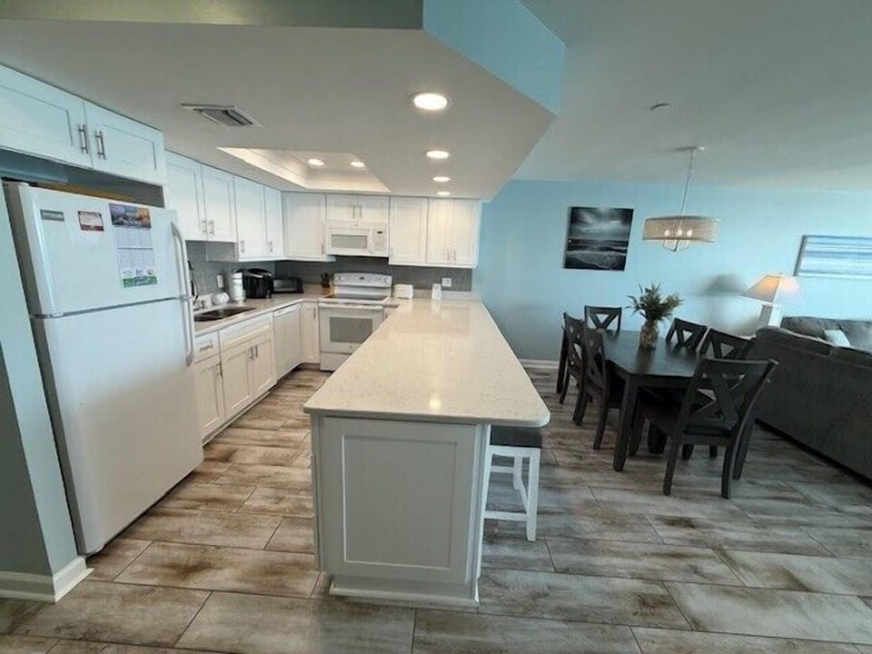 Gather around this spacious kitchen island for morning coffee or evening meals in your bright, open-concept living space.