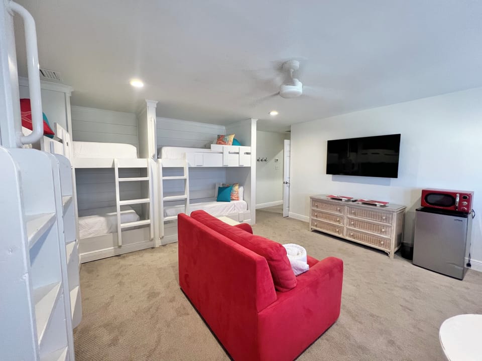 The bunk room has a private bathroom, TV, gaming system, mini fridge and microwave