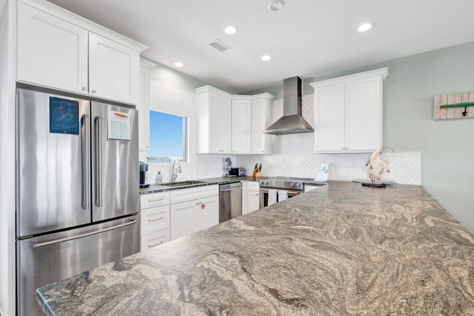 Featuring stainless appliances and stone counters