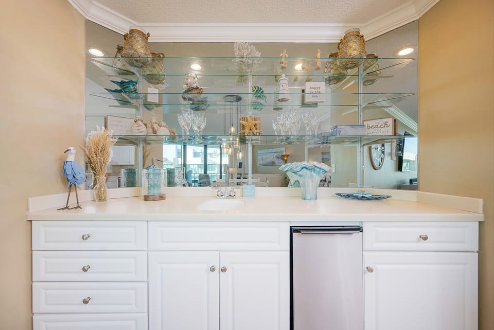 Sip refreshing drinks from elegant glassware at the stylish wet bar, perfectly complementing your retreat