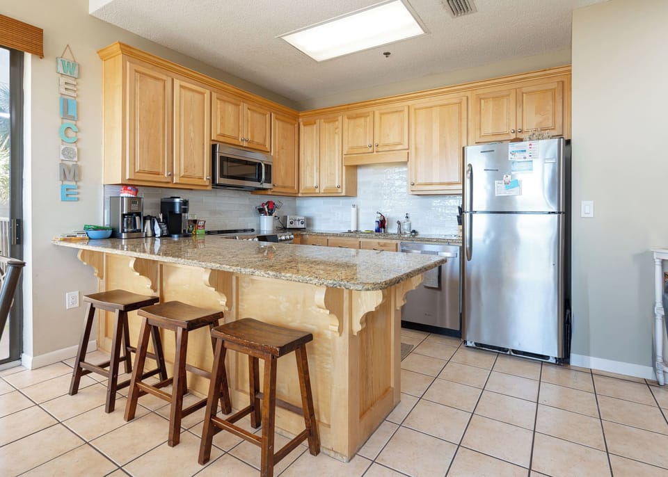 Enjoy morning coffee at the breakfast bar, share smiles, and enjoy casual conversations as you prepare for a beach day