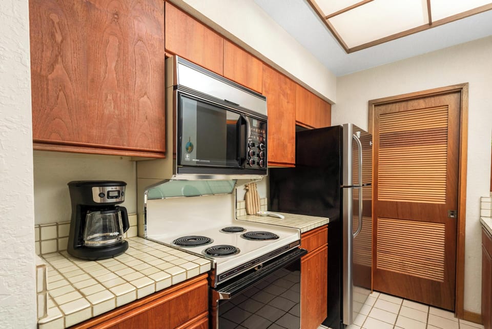 Your fully equipped kitchen features warm wood cabinetry, modern appliances, and everything you need to create delicious home-cooked meals.