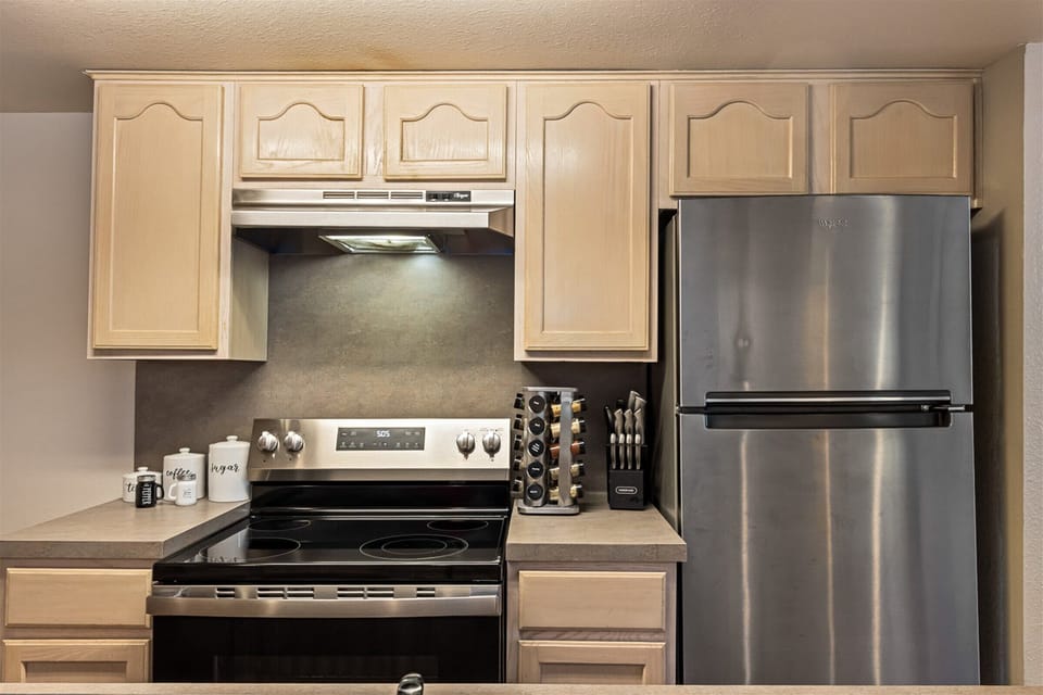 Full-size stainless steel appliances for easy cooking.
