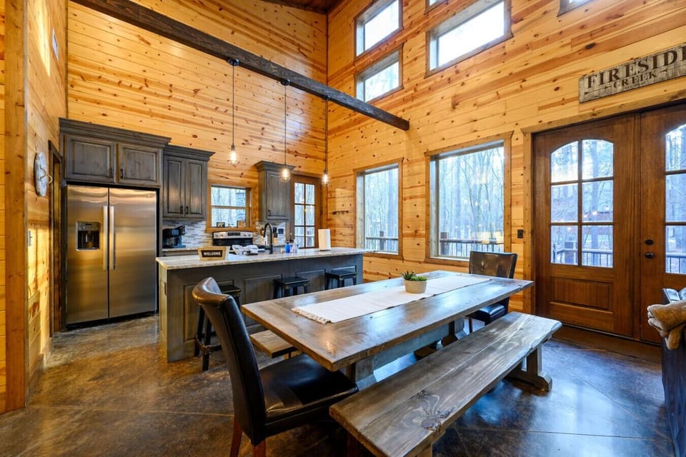This gorgeous open-concept log cabin has soaring ceilings, a chef`s kitchen, and windows overlooking the forest from every angle.