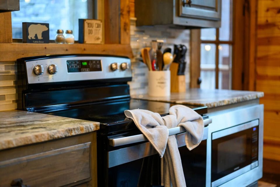 Modern stainless steel appliances and natural wood finishes create a warm, well-equipped kitchen perfect for preparing meals during your stay.