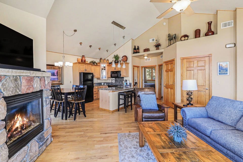 Cozy up by your stone fireplace while enjoying this open-concept space with vaulted ceilings, full kitchen, and mountain cabin charm.