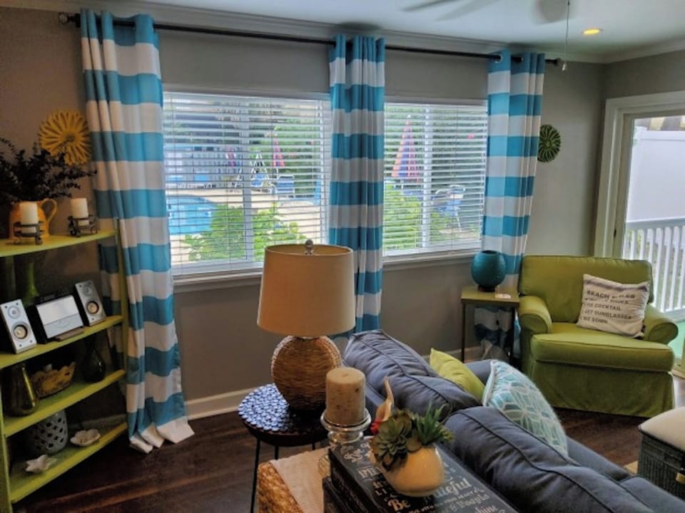 Relax in the comforts of this living room overlooking the pool.