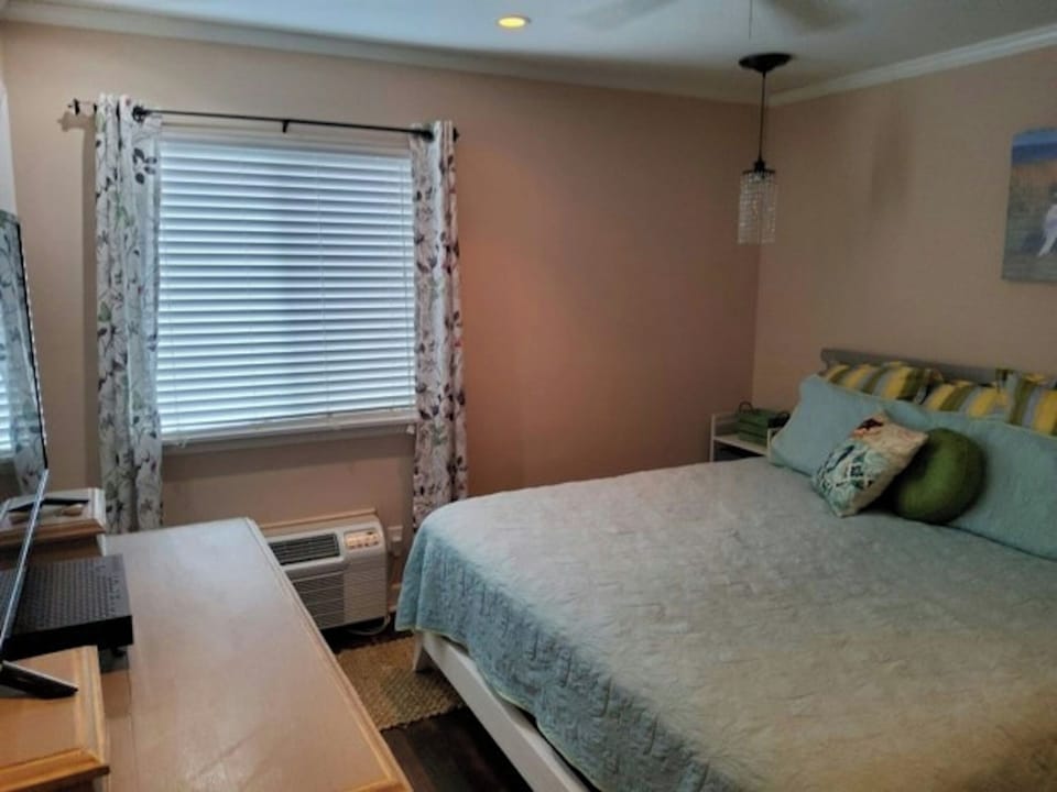 Get a good night's sleep in this cozy bedroom and then head out to the beach.