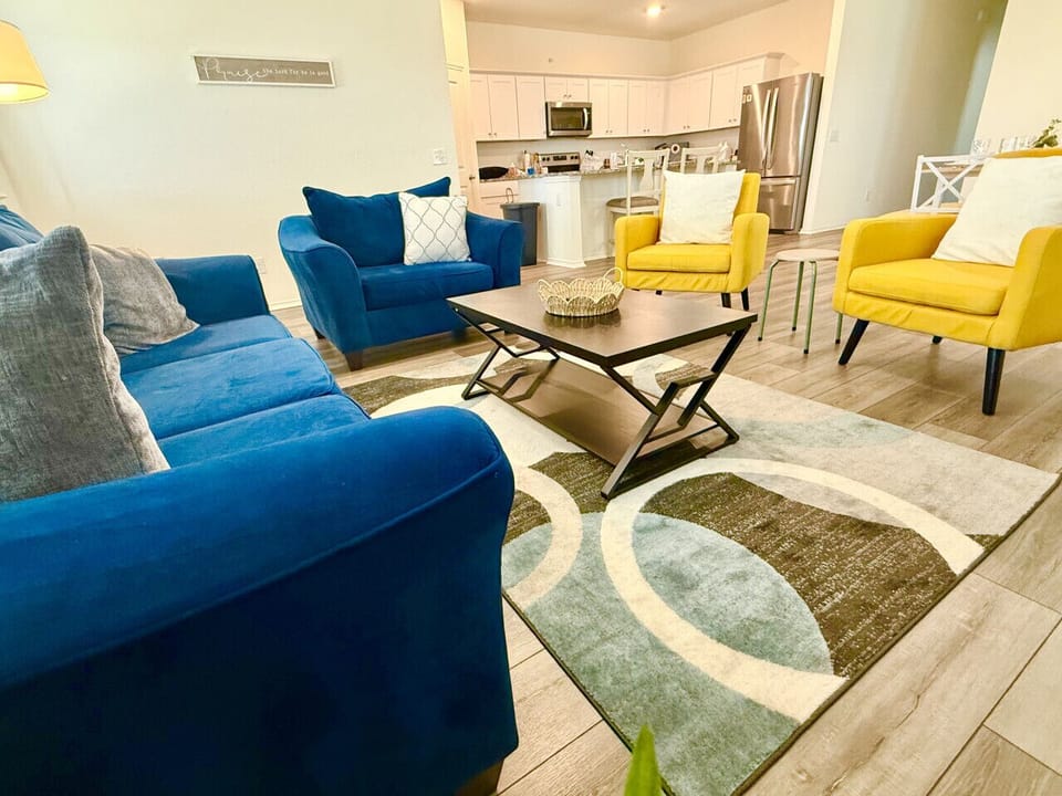 Unwind in the expansive living room, featuring a seamless open floor plan that flows into the kitchen/dining area.