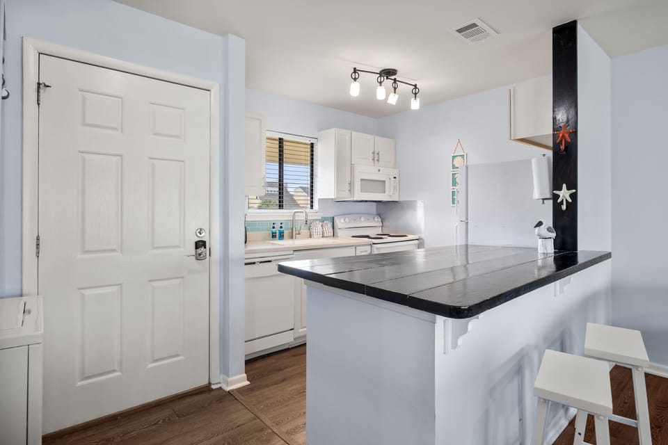 Your bright kitchen features sleek granite countertops and modern appliances, perfect for preparing meals during your stay.