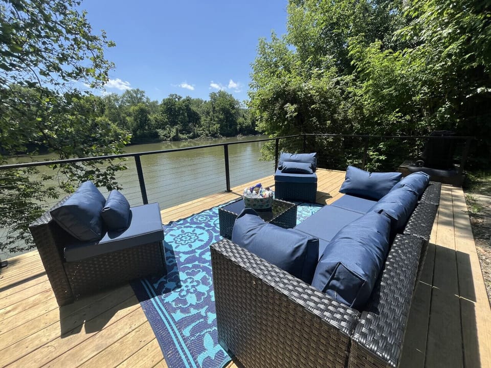 Escape to the serene furnished deck, where you can soak in the tranquil views of the river. Delight in culinary creations at the well-appointed grilling area, and gather around the inviting firepit for memorable conversations under the stars. Enjoy the ul