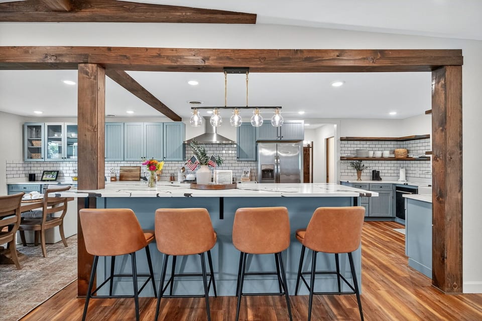 Chic chef’s kitchen with large island, bar seating, and stainless steel