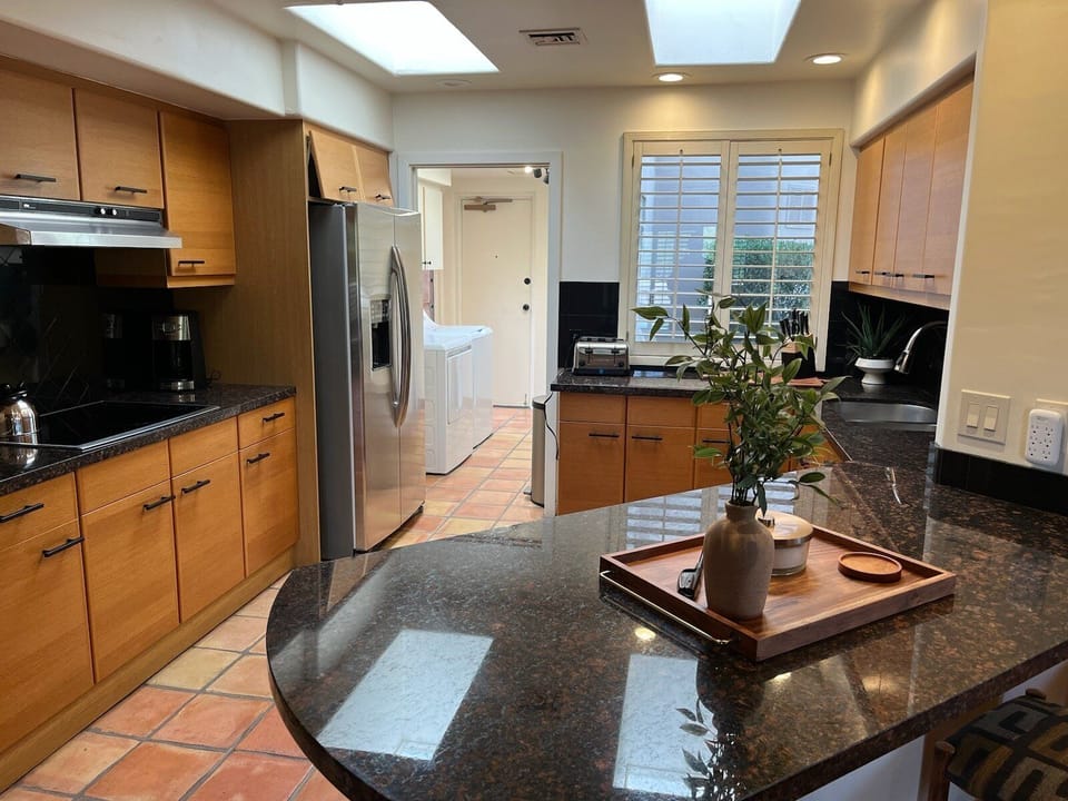Modern kitchen is completely stocked for prepping and serving home cooked meals.