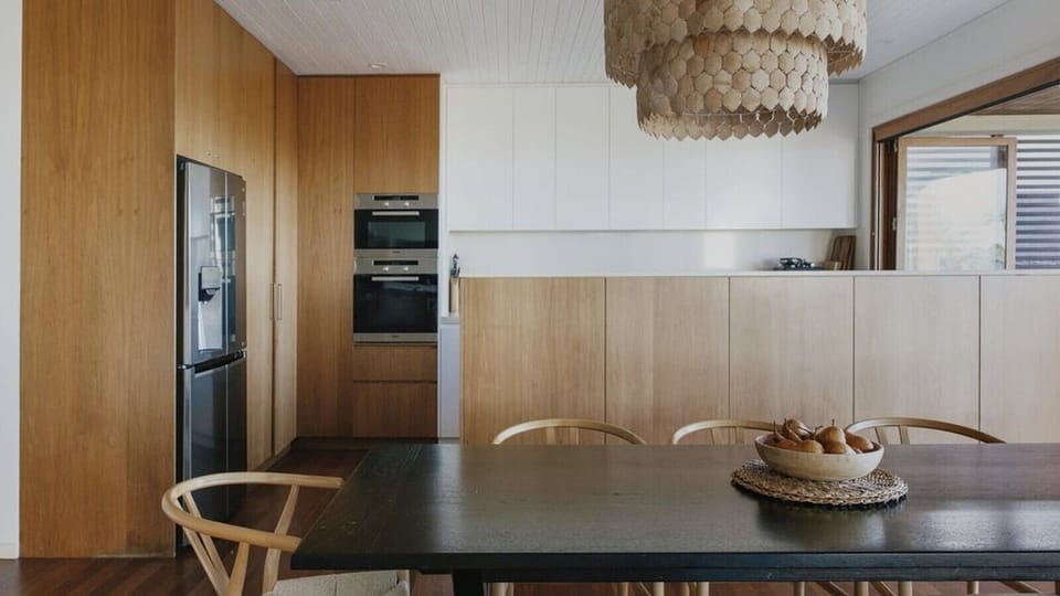 Fully equipped designer kitchen with stone island bench and premium appliances for effortless self-catering.