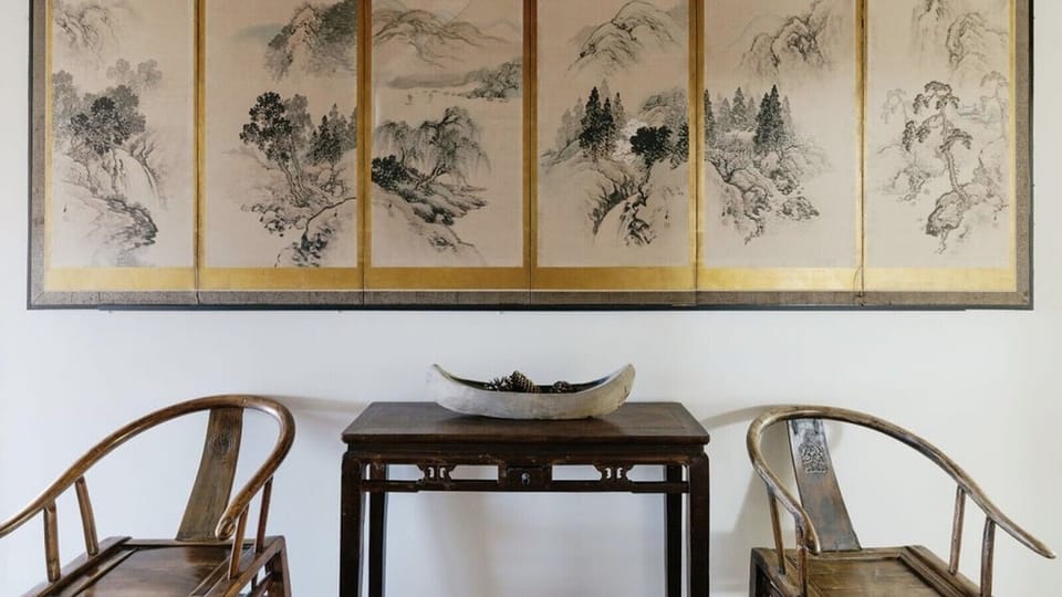 Characterful dining nook with statement artwork, adding warmth to this coastal home.