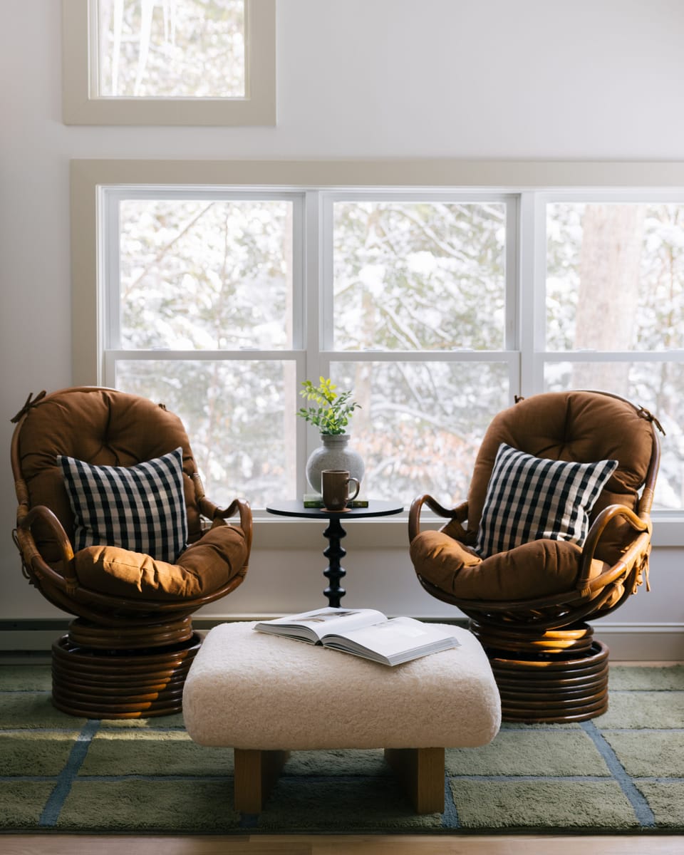Relax in a cozy reading nook with wooded views and morning coffee