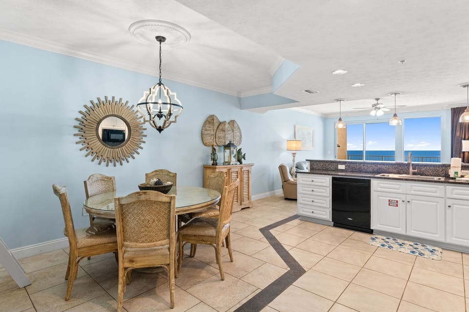 There is a dining table, perfect for enjoying a meal or playing a game, as well as additional breakfast bar seating.