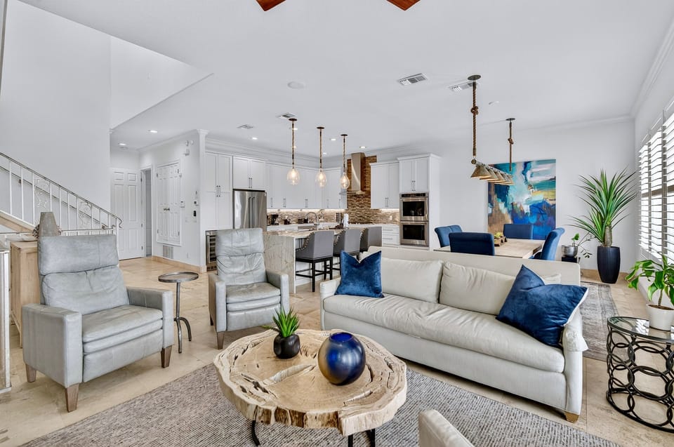 2nd Floor - Spacious great room designed for gathering at SunnySide, featuring open-concept living, designer coastal furnishings, abundant natural light, and a modern linear fireplace—perfect for relaxing, entertaining, and unwinding after beach days.
