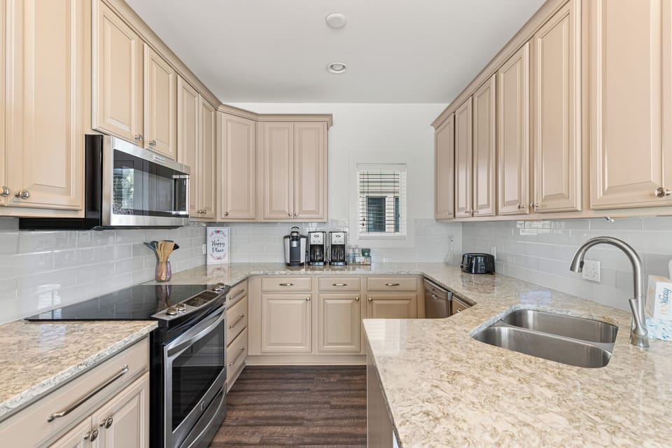 Your fully equipped kitchen awaits with granite counters, modern appliances, and everything you need to create memorable meals together.