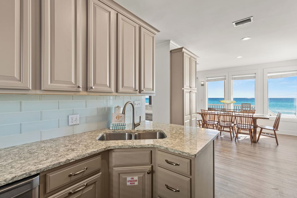 Your fully equipped kitchen opens to stunning ocean views, creating the perfect backdrop for morning coffee and meal prep.