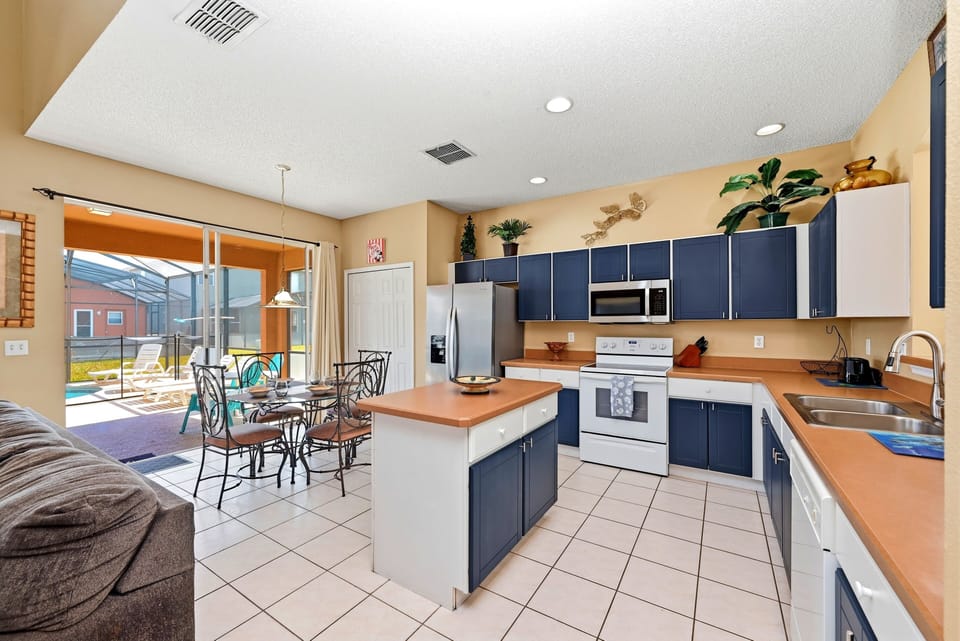 The kitchen is fully stocked and features an island.