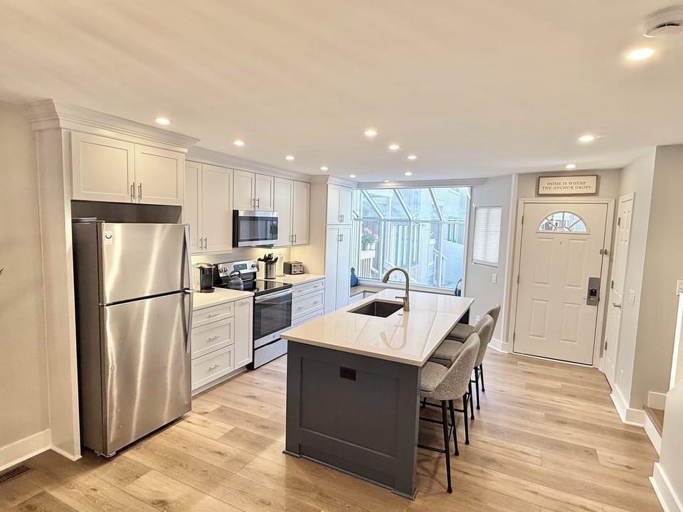 New kitchen with quartz countertops, full-size pantry, and upgraded cabinets