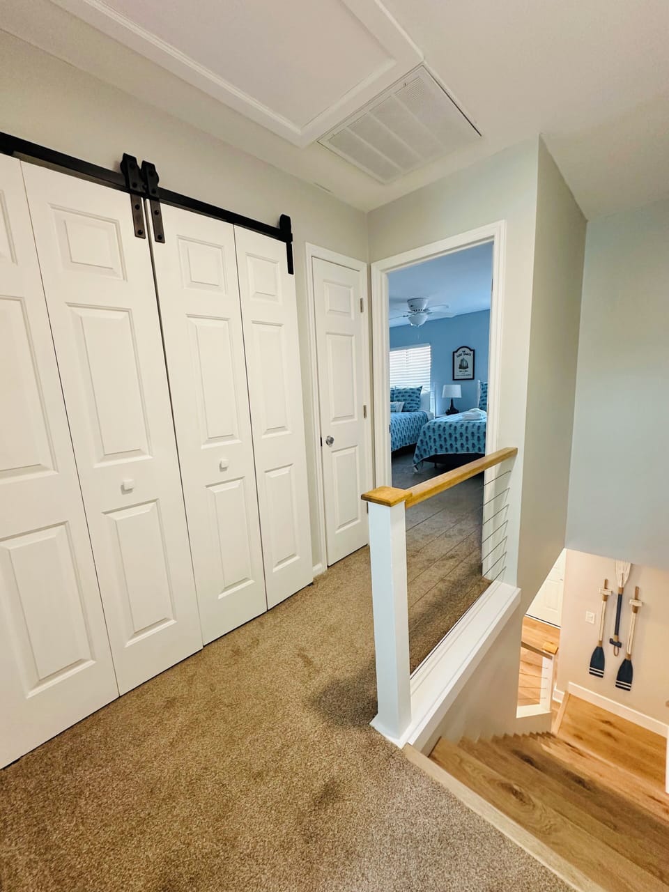 The second floor laundry area is concealed by unique sliding barn doors.