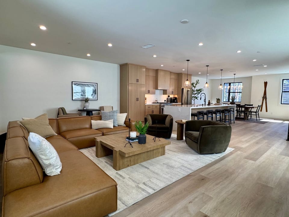 Living room has plenty of seating and nice leather sectional.