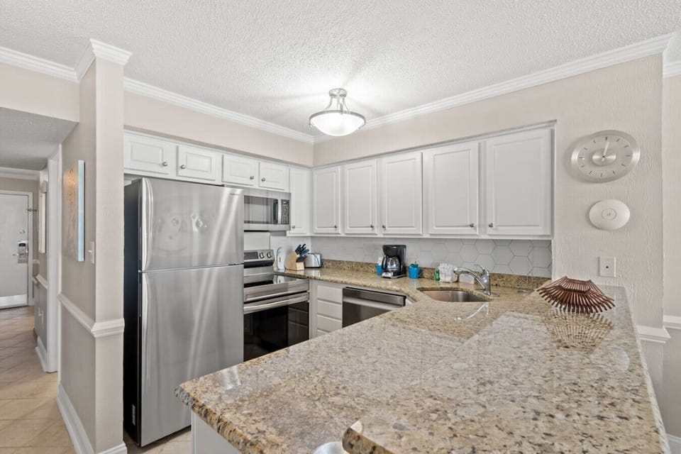 Fully equipped kitchen with stainless steel major appliances, offering everything needed for cooking, dining, and enjoying meals during your stay.