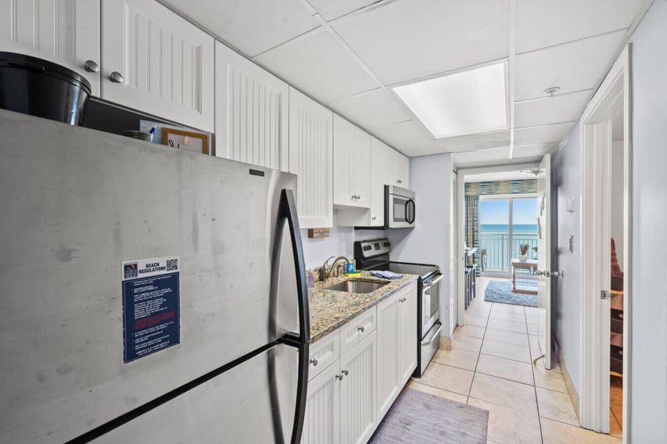 Bright full kitchen filled with natural lighting and equipped with all major appliances. Designed for easy vacation meals, snacks, and morning coffee while enjoying the comfort of a complete Myrtle Beach kitchen space.