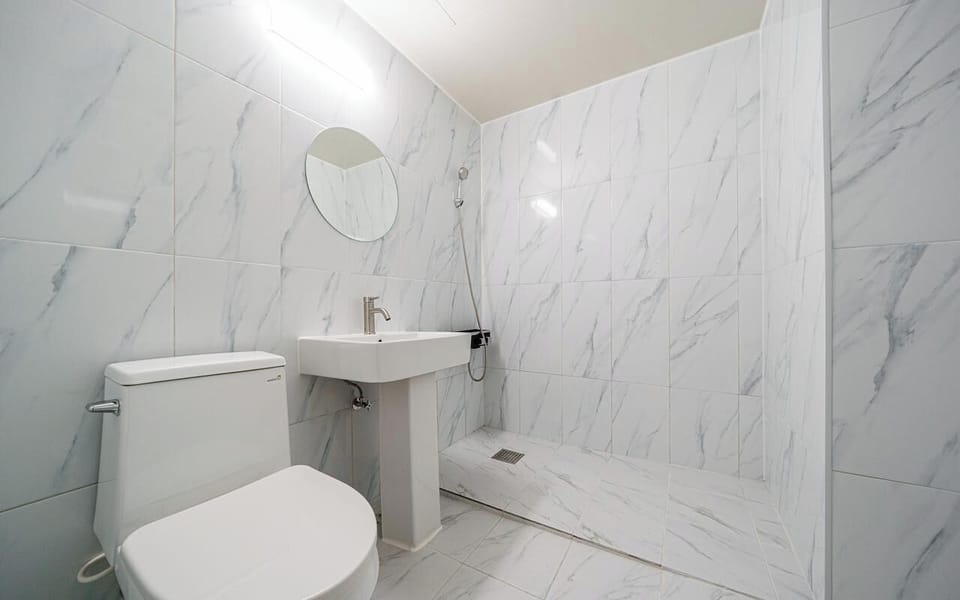 Shower, hair dryer, slippers, towels