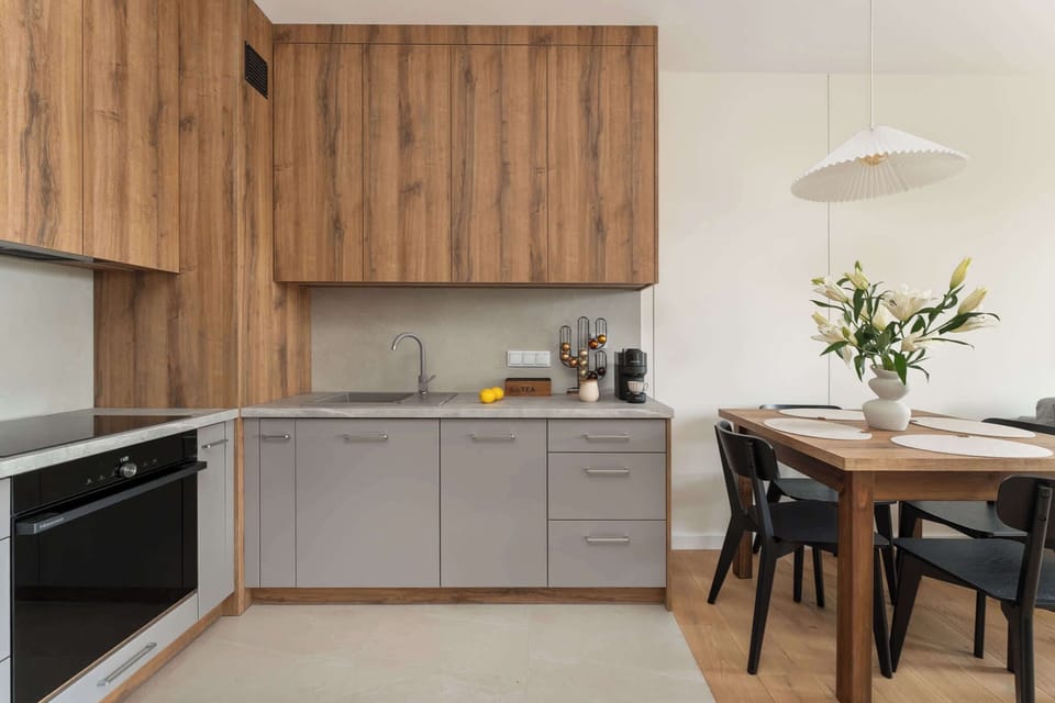 Dining area next to the kitchenette with a table and chairs for four, perfect for meals or remote work.