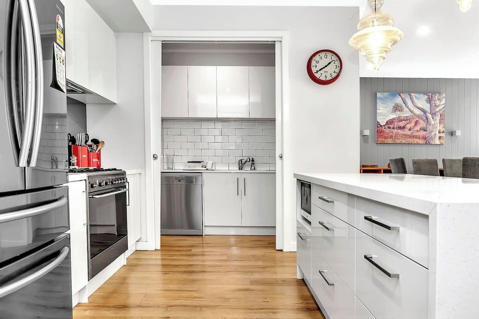 Fully equipped kitchen with gas cooktop and butler`s pantry.