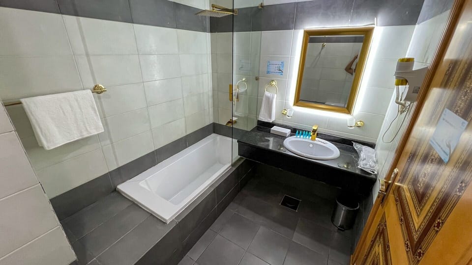 Combined shower/tub, hair dryer, towels, soap