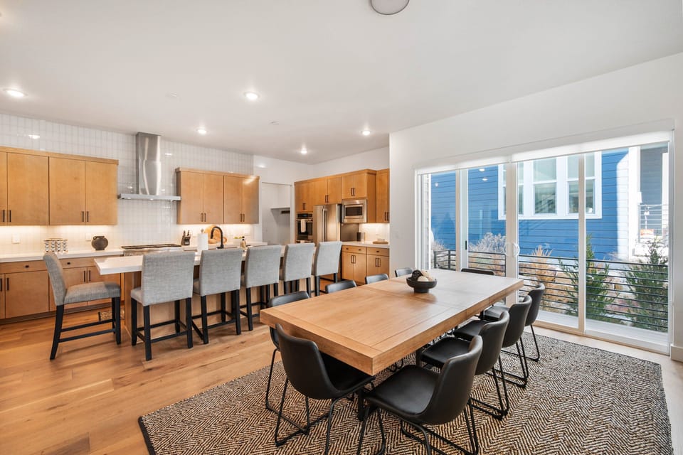 An oversized Dining room with seating for 10 at the table and another 6 at the kitchen island