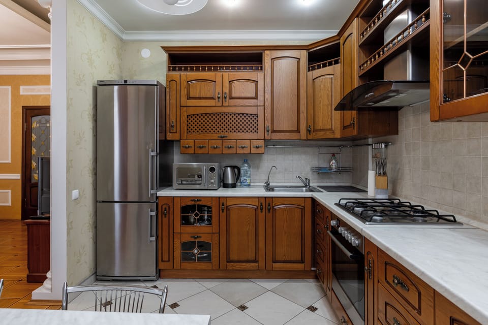 Deluxe Apartment, Non Smoking, Courtyard View | Private kitchen | Electric kettle, cleaning supplies, paper towels, dining table