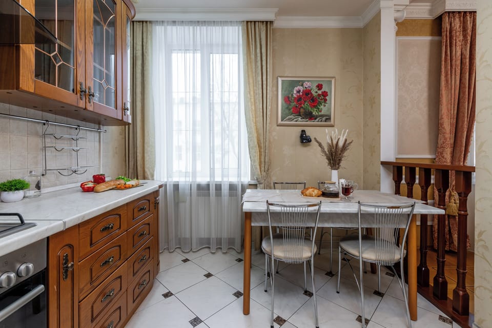 Deluxe Apartment, Non Smoking, Courtyard View | Private kitchen | Electric kettle, cleaning supplies, paper towels, dining table