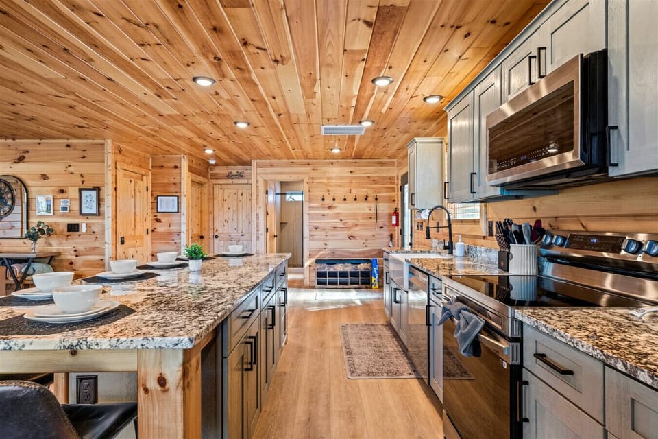 This fully equipped kitchen features granite countertops, stainless appliances, and a spacious island perfect for gathering. Whether you’re cooking breakfast or hosting dinner, there’s room for everyone to join in.