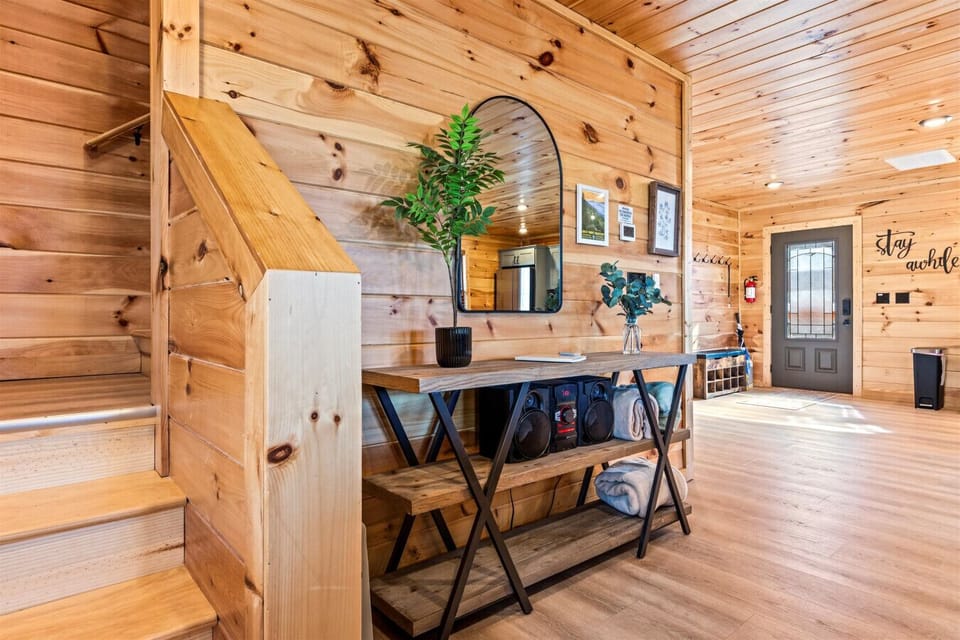 Head up to the stairs to the second level of the cabin. This level includes a king bedroom, full bathroom, game room, sleeper sofa, and private balcony.