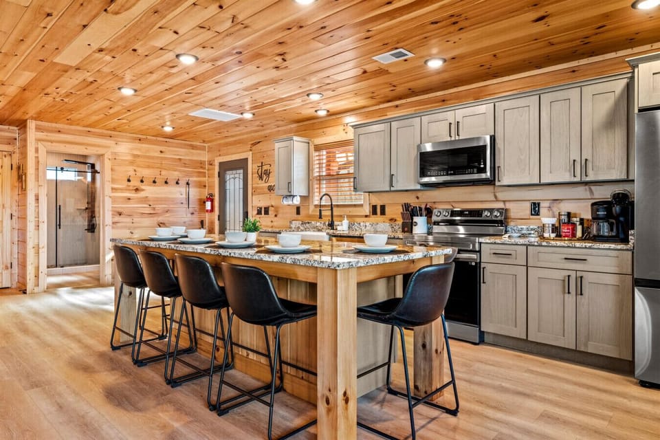 With generous counter space and modern finishes, this fully equipped kitchen makes preparing meals easy while keeping everyone together in one warm, inviting space.