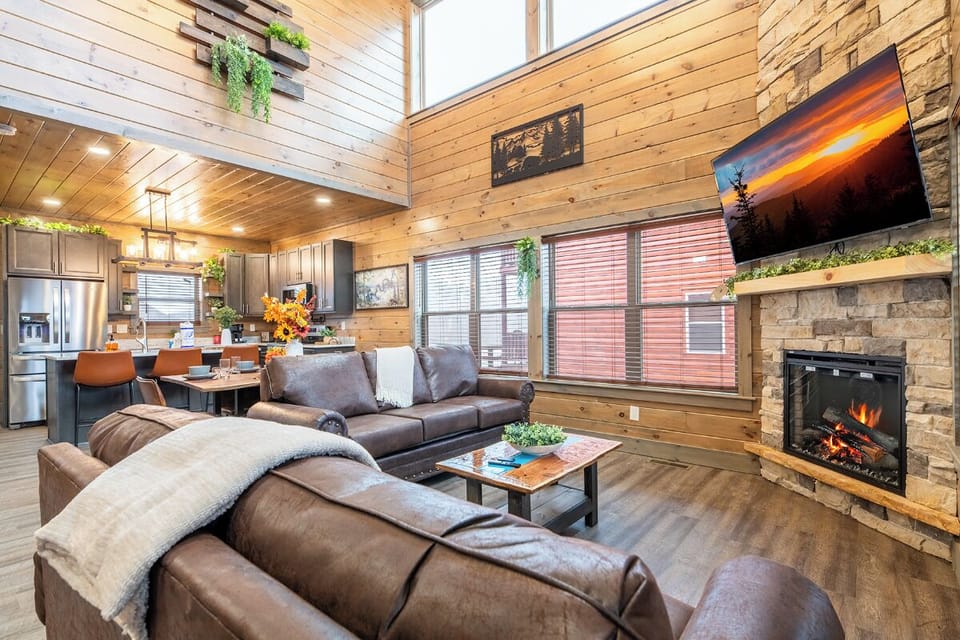 Curl up on plush leather seating by your crackling fireplace, surrounded by warm wood and modern mountain comfort.