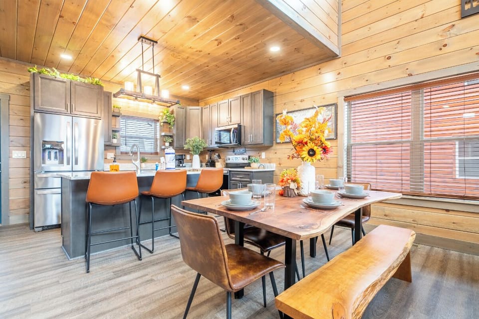 Gather around this warm cabin kitchen where rustic wood meets modern comfort. Your group will love cooking and sharing meals together.