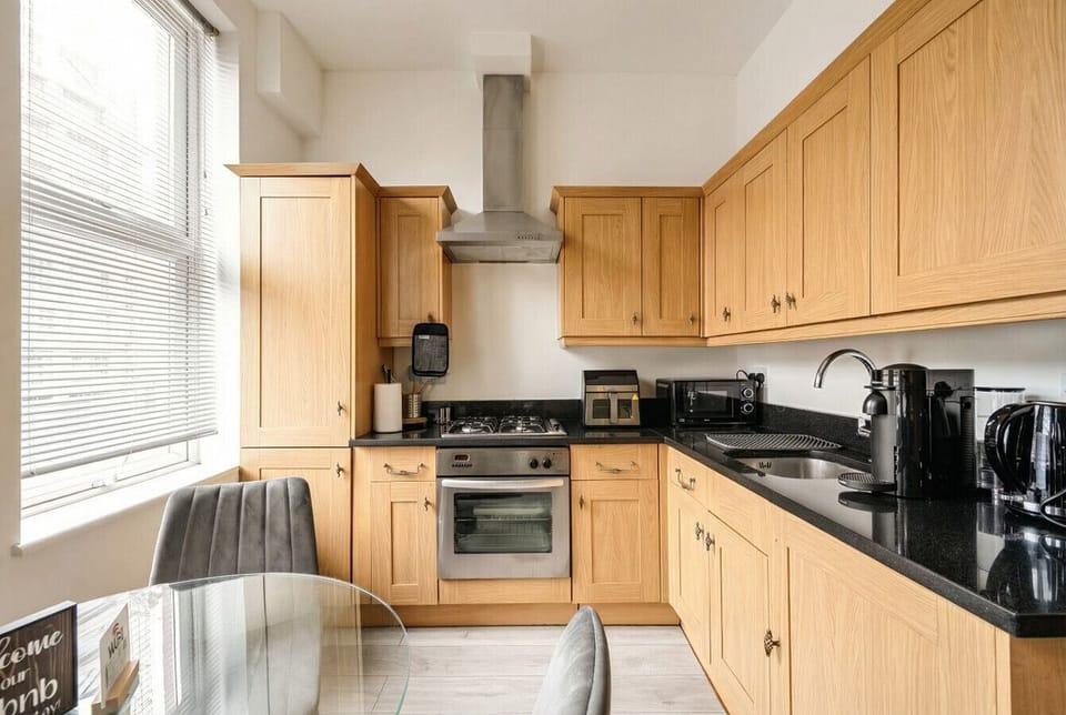 Fully equipped kitchen with gas hob, oven, Nespresso machine and plenty of storage.