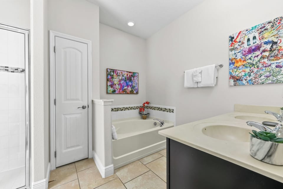 BATH #1 (1st Floor):  Ensuite (OWNER’S SUITE #1) Bathroom with Double Sink Vanity, Shower & Garden Tub 