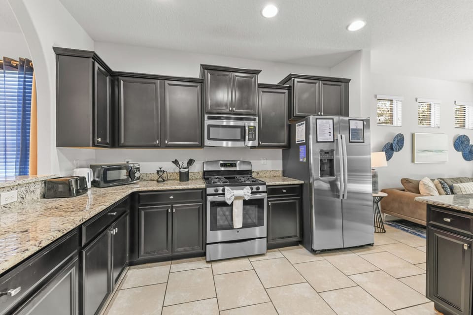 KITCHEN:  Fully Equipped Kitchen with Side-by-Side Refrigerator, Microwave, Gas Stove, Oven, Dishwasher and Toaster