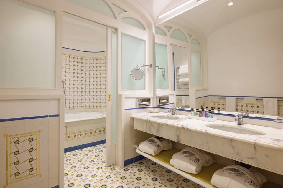 Suite, Partial Sea View | Bathroom | Combined shower/tub, free toiletries, hair dryer, bidet