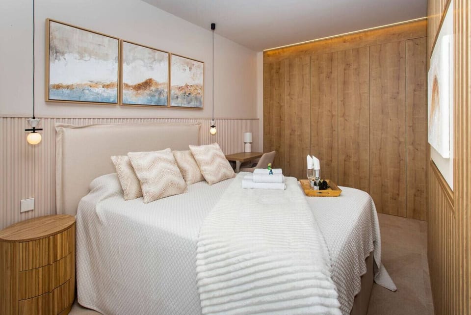 The elegance of our floor-to-ceiling fitted wardrobes seamlessly integrated with fluted wood textures Designed for the modern traveler these spacious units feature warm LED accent lighting to showcase your belongings in style Order elevated