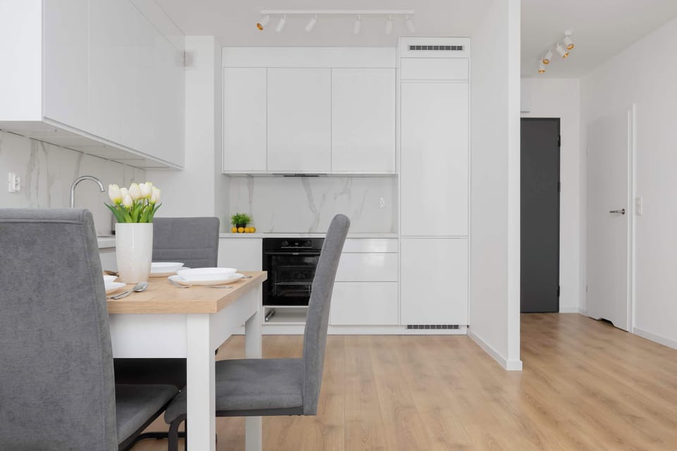 Open layout showing dining table connected to the kitchenette.