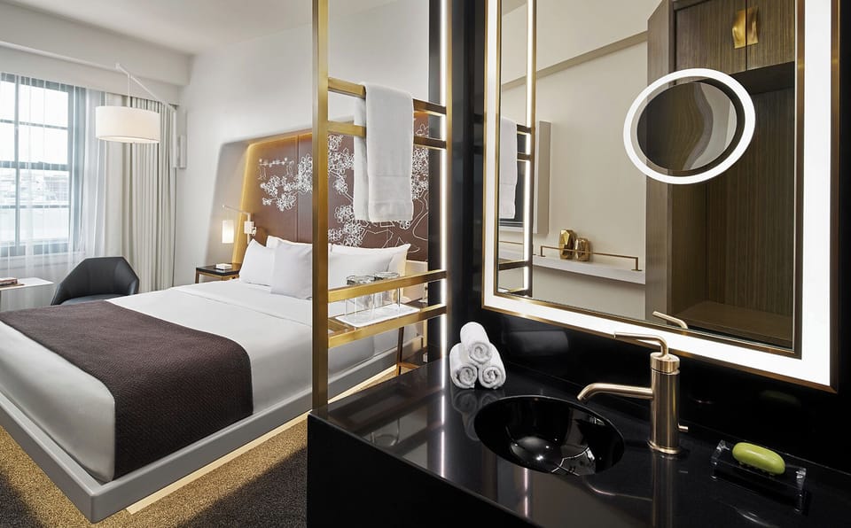 Unwind in a sleek suite with spa-style vanity glow.